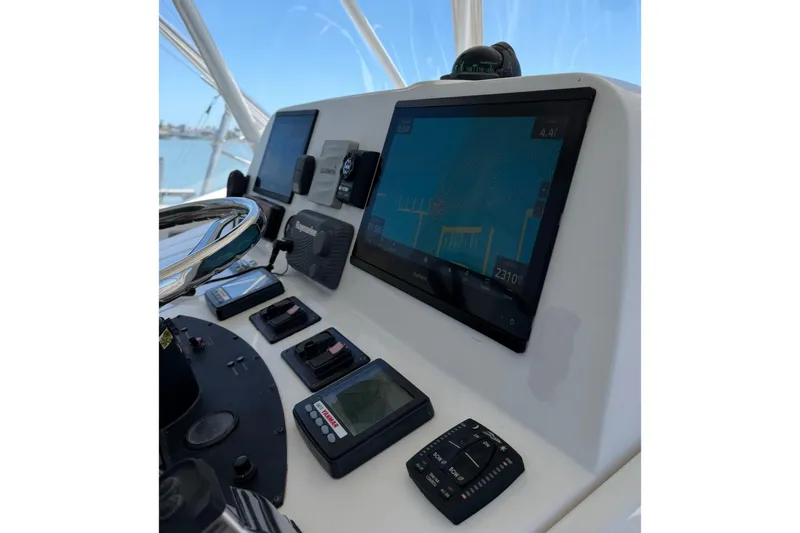 Slide: The Image of Control panel of 2008 Luhrs 35 Convertible boat with navigation screens and instruments. - 13