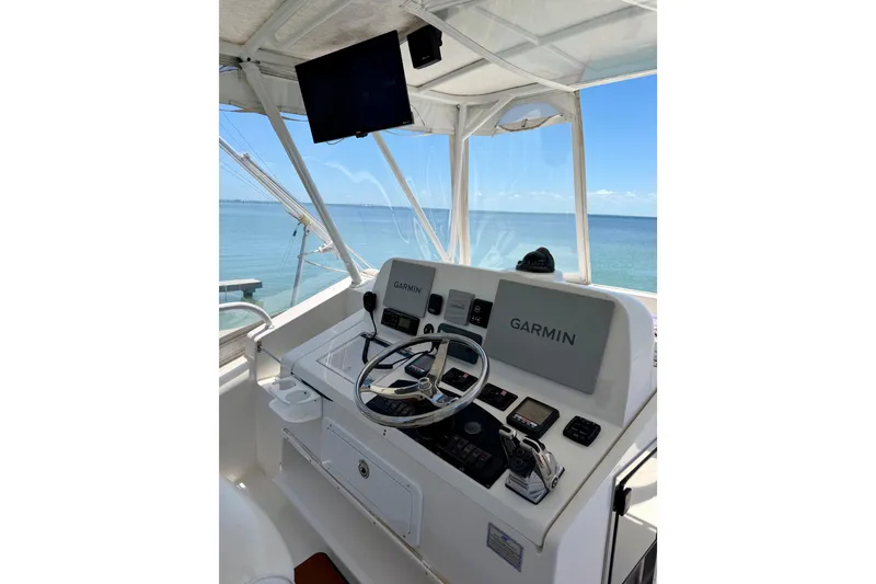 Slide: The Image of Helm of 2008 Luhrs 35 Convertible boat with Garmin navigation system, overlooking the ocean. - 15