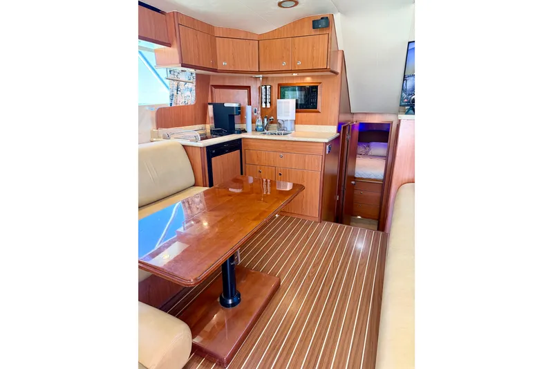Slide: The Image of Interior of 2008 Luhrs 35 Convertible yacht with wood finish and cozy seating area. - 20