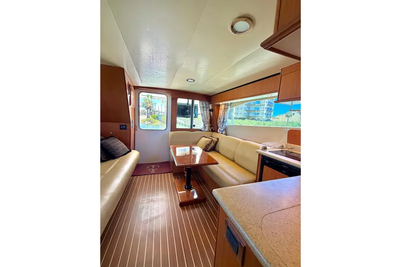 Slide: The Image of Interior of 2008 Luhrs 35 Convertible yacht with elegant seating and wooden flooring. - 21