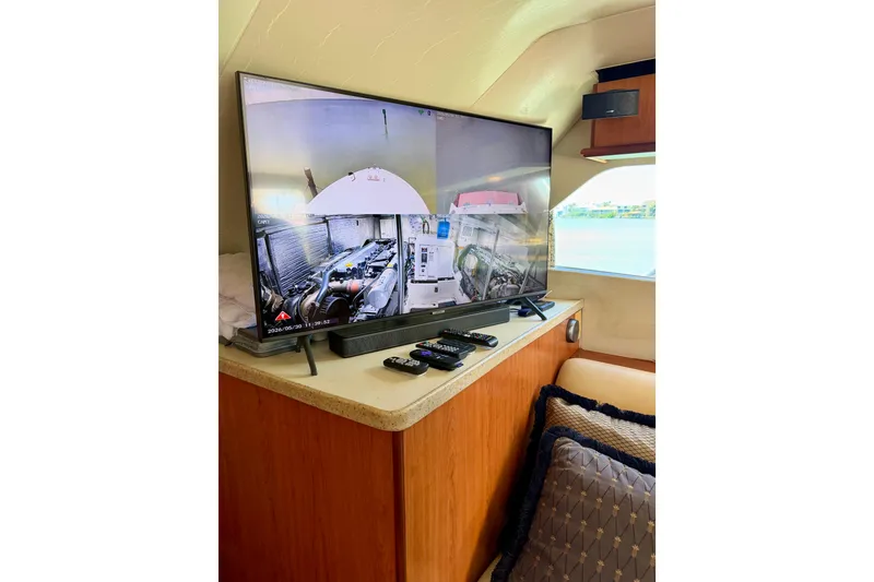 Slide: The Image of Interior of 2008 Luhrs 35 Convertible yacht with TV and remote controls. - 22