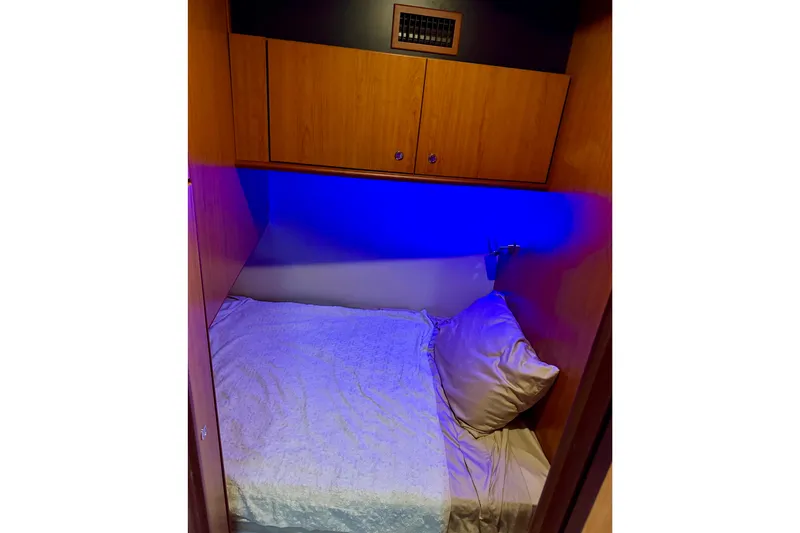 Slide: The Image of Cozy cabin bed with blue lighting in 2008 Luhrs 35 Convertible boat. - 25