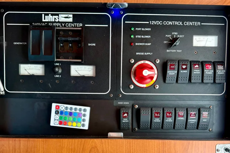 Slide: The Image of Control panel of a 2008 Luhrs 35 Convertible boat with switches and gauges. - 26