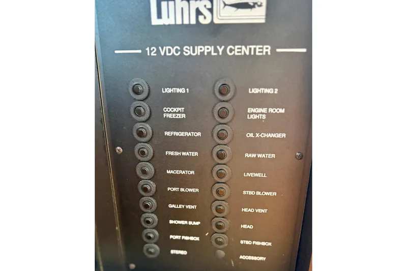 Slide: The Image of Control panel of a 2008 Luhrs 35 Convertible boat, featuring various electrical switches. - 28