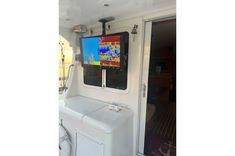 Slide: The Image of 2008 Luhrs 36 Convertible boat interior with mounted fish finder display. - 3