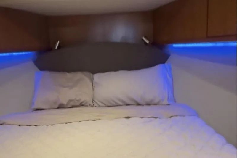 Slide: The Image of Luxurious bedroom interior of 2008 Luhrs 36 Convertible yacht with ambient blue lighting. - 8