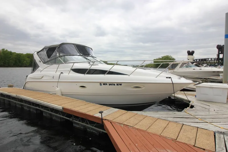 The Image of 2001 Bayliner 3055 Ciera docked at marina under cloudy sky. - 0
