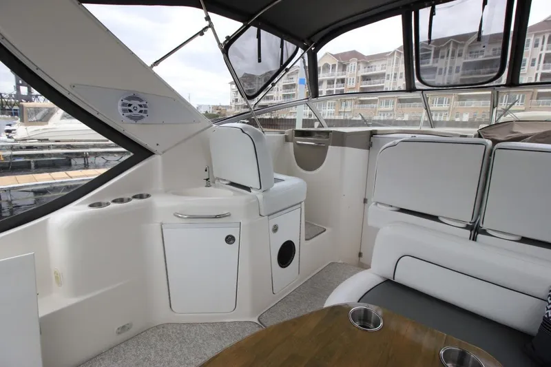 Slide: The Image of 2001 Bayliner 3055 Ciera boat interior with seating and table, docked at marina. - 10