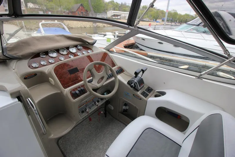 Slide: The Image of 2001 Bayliner 3055 Ciera cockpit with steering wheel, control panel, and comfortable seating. - 12