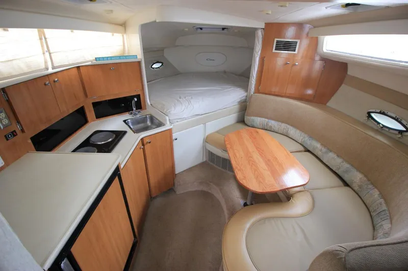 Slide: The Image of Interior of 2001 Bayliner 3055 Ciera boat with kitchenette, seating, and sleeping area. - 14