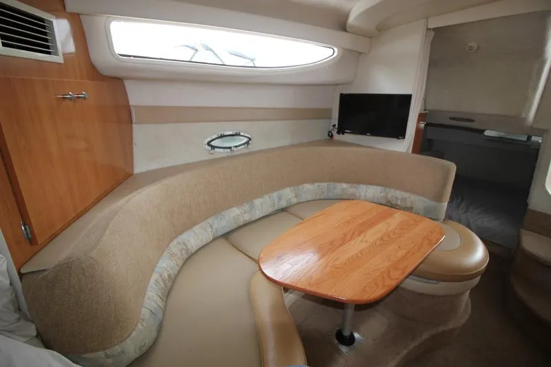 Slide: The Image of Interior of 2001 Bayliner 3055 Ciera with cozy seating and wooden table. - 17