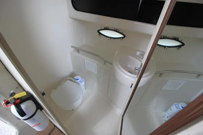 Slide: The Image of 2001 Bayliner 3055 Ciera boat bathroom with toilet, sink, and fire extinguisher. - 21