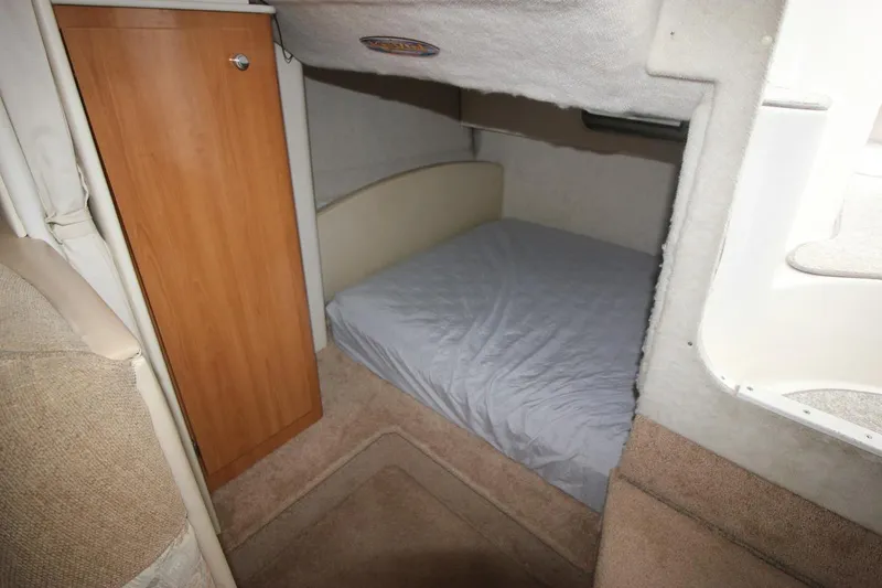 Slide: The Image of 2001 Bayliner 3055 Ciera cabin interior with bed and wooden cabinet. - 25