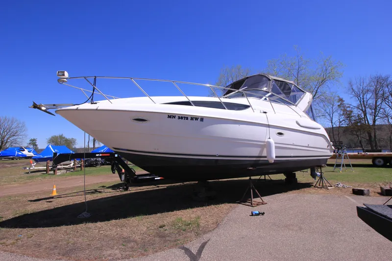 Slide: The Image of 2001 Bayliner 3055 Ciera boat on land, clear sky background. - 27
