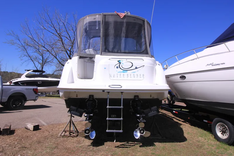 Slide: The Image of 2001 Bayliner 3055 Ciera boat on land, rear view with propellers visible. - 28