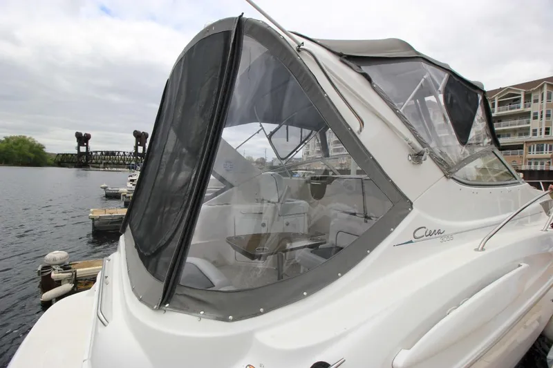 Slide: The Image of 2001 Bayliner 3055 Ciera boat docked by waterfront with clear canopy enclosure. - 4