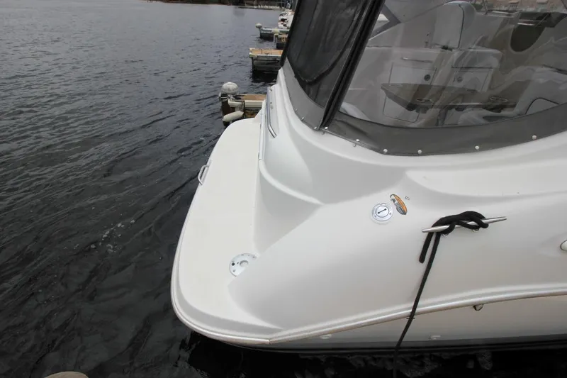 Slide: The Image of 2001 Bayliner 3055 Ciera docked, showing rear deck and water view. - 5