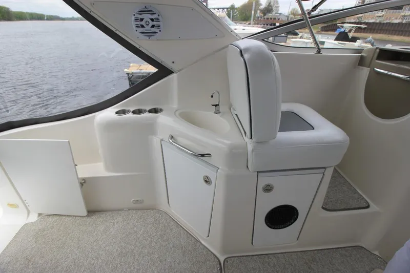 Slide: The Image of 2001 Bayliner 3055 Ciera boat interior with seating, sink, and storage compartments. - 6