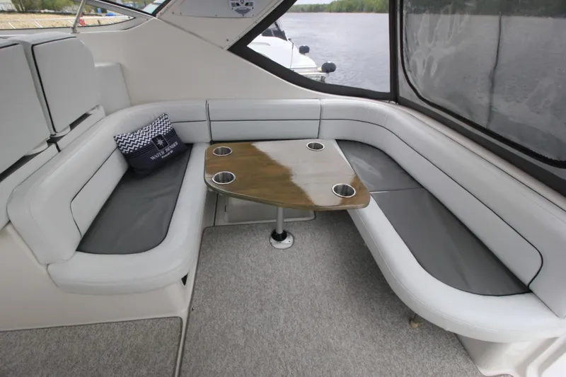 Slide: The Image of Interior of 2001 Bayliner 3055 Ciera boat with cushioned seating and table. - 9