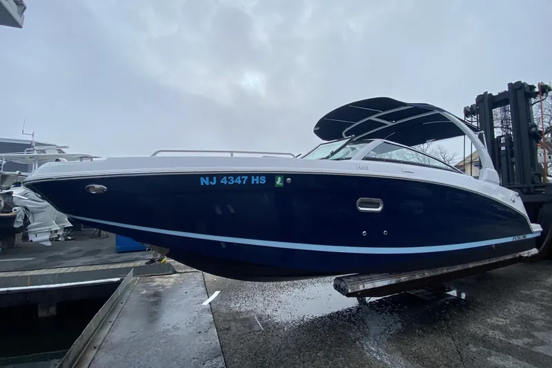 The Image of 2023 Four Winns HD8 boat with blue hull, docked and ready for launch. - 0