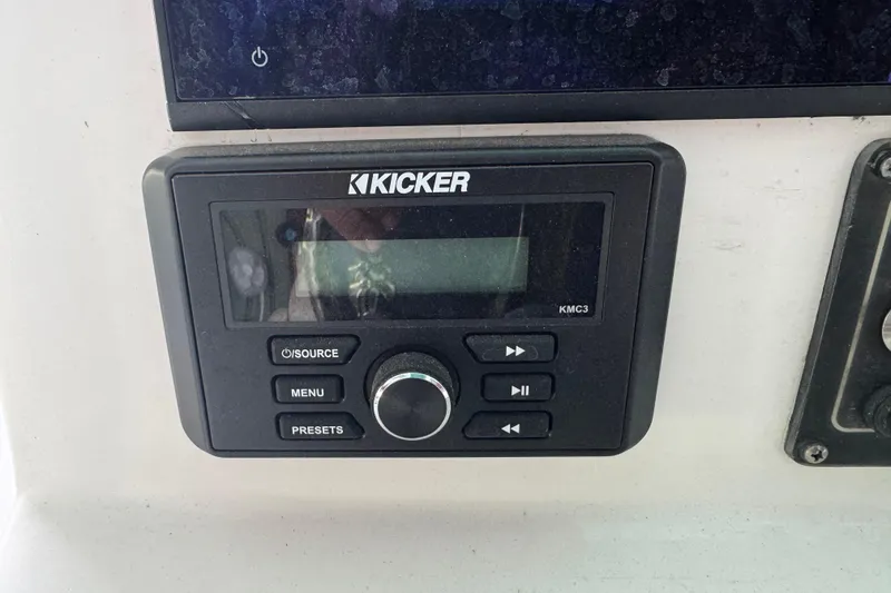Slide: The Image of Kicker KMC3 audio system on 2018 Sea Fox 249 Avenger boat dashboard. - 12