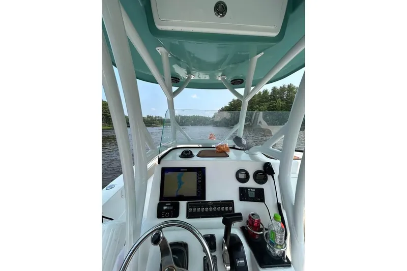 Slide: The Image of Interior view of 2018 Sea Fox 249 Avenger boat with navigation equipment and scenic waterway. - 2