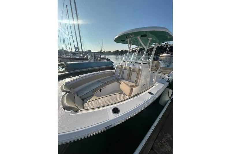Slide: The Image of 2018 Sea Fox 249 Avenger boat docked, featuring spacious seating and sleek design. - 3