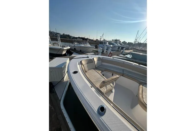 Slide: The Image of 2018 Sea Fox 249 Avenger boat docked at marina under clear blue sky. - 4