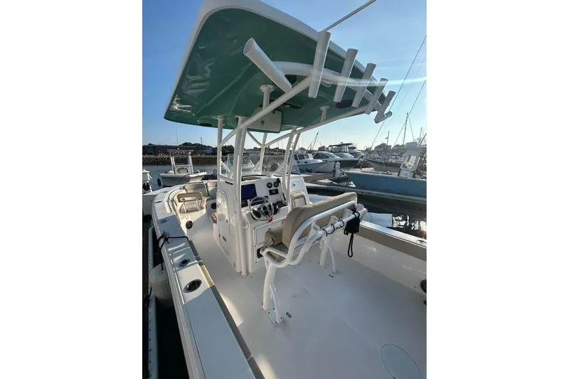 Slide: The Image of 2018 Sea Fox 249 Avenger boat with T-top and helm, docked at marina. - 7