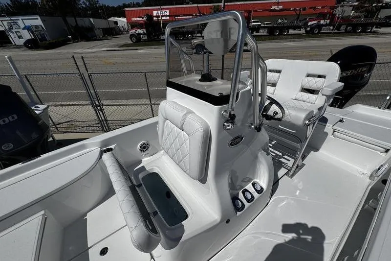 Slide: The Image of 2026 Blazer Bay 2200 boat interior with white seating and steering console. - 10
