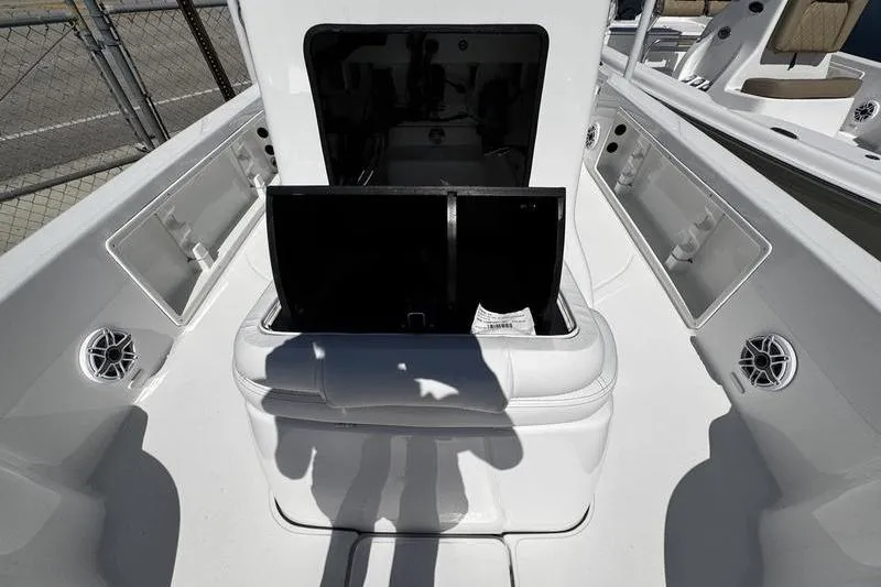 Slide: The Image of 2026 Blazer Bay 2200 boat interior with open storage compartment and seating. - 12