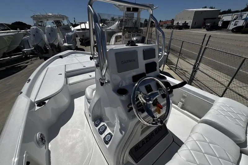 Slide: The Image of 2026 Blazer Bay 2200 boat interior with Garmin navigation system and steering console. - 14