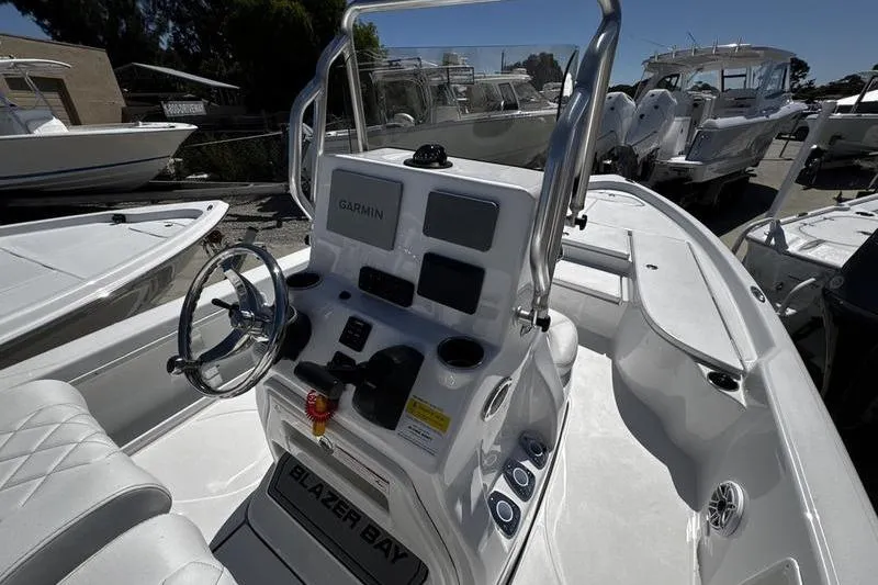 Slide: The Image of 2026 Blazer Bay 2200 boat with Garmin navigation, sleek design, and modern controls. - 15