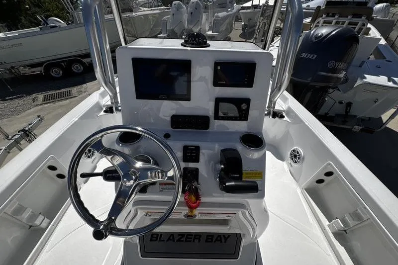 Slide: The Image of Blazer Bay 2200 boat dashboard with steering wheel and control panel, 2026 model. - 16