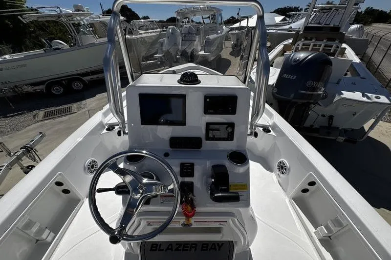 Slide: The Image of 2026 Blazer Bay 2200 boat dashboard with steering wheel and controls. - 17