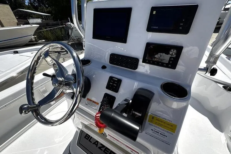 Slide: The Image of 2026 Blazer Bay 2200 boat dashboard with steering wheel and electronic displays. - 18