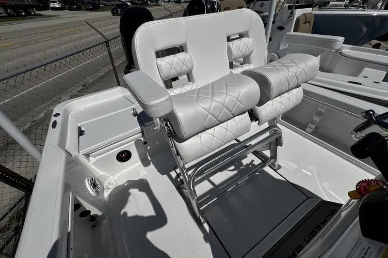 Slide: The Image of 2026 Blazer Bay 2200 boat with white cushioned seating and stainless steel frame. - 19