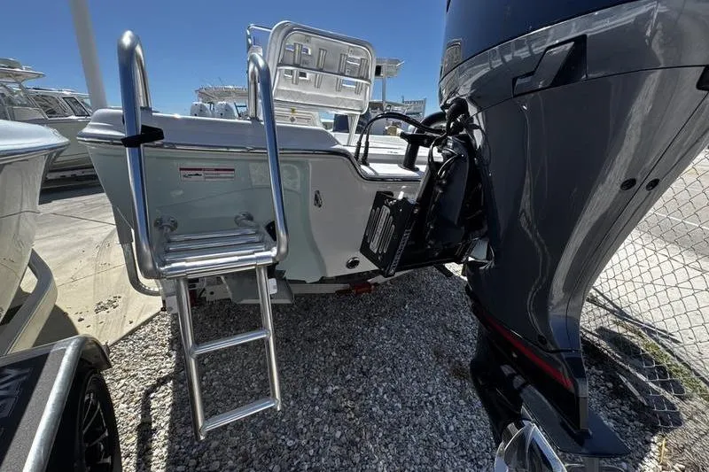 Slide: The Image of 2026 Blazer Bay 2200 boat with ladder and powerful outboard motor. - 4