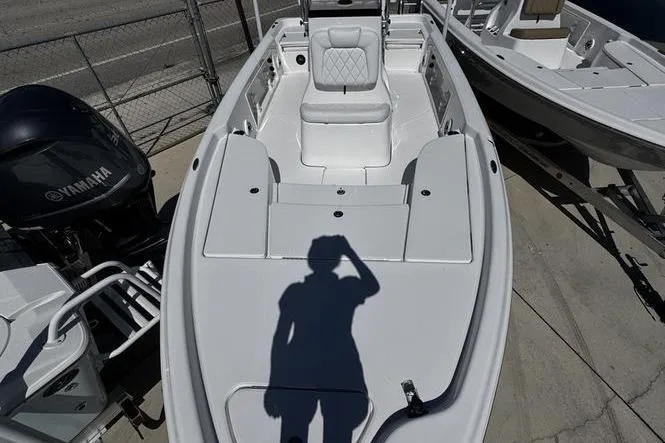 Slide: The Image of 2026 Blazer Bay 2200 boat with Yamaha engine, docked, shadow of person visible. - 7