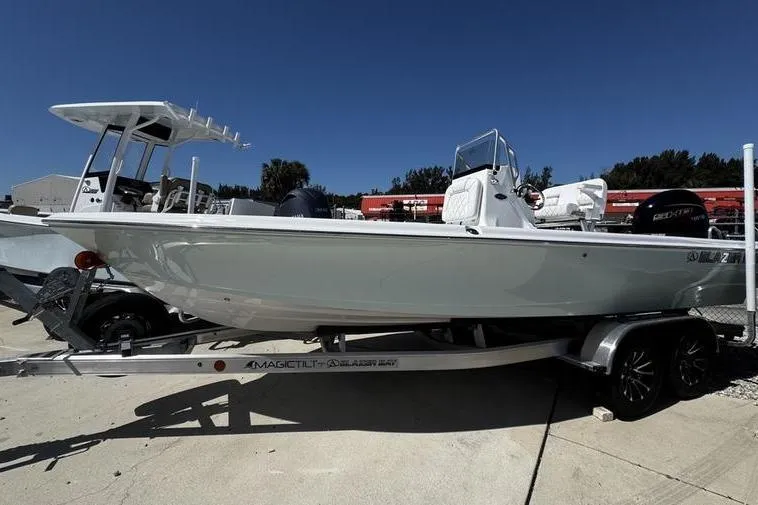 The Image of 2026 Blazer Bay 2200 boat on trailer under clear blue sky. - 1