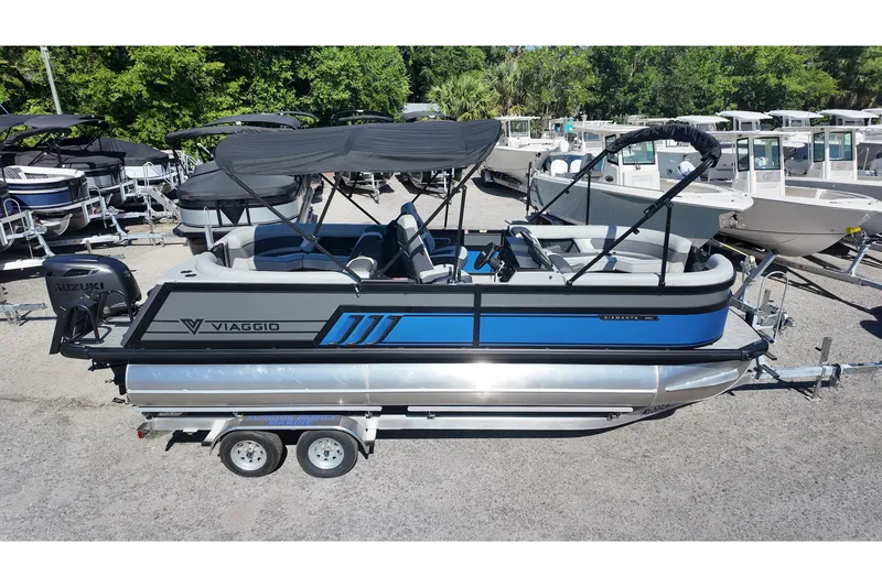 Slide: The Image of 2026 Viaggio Diamante U 22 pontoon boat with Suzuki engine, parked on trailer. - 1