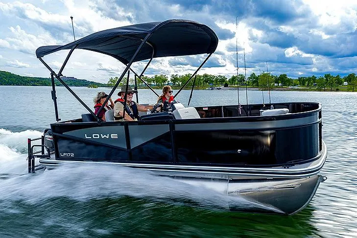 The Image of Manufacturer Provided Image: 2025 Lowe LF 172 pontoon boat cruising on a lake under a cloudy sky. - 0