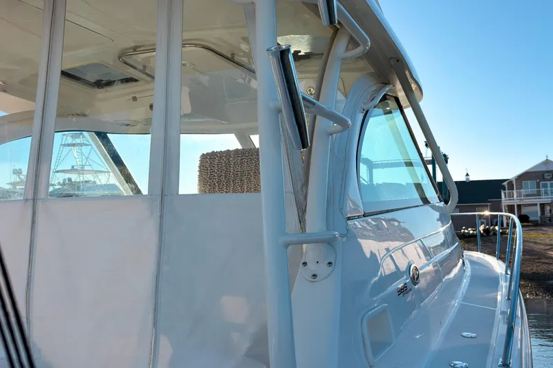 Slide: The Image of 2021 Pursuit OS 385 Offshore boat, showcasing sleek design and modern features in a marina setting. - 12