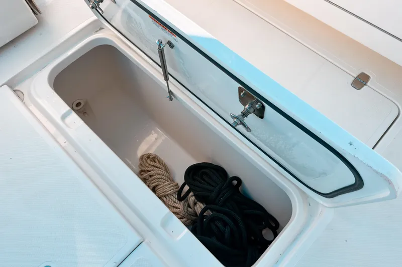 Slide: The Image of Storage compartment with ropes on a 2021 Pursuit OS 385 Offshore boat. - 15