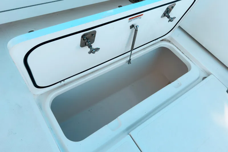 Slide: The Image of Open storage compartment on 2021 Pursuit OS 385 Offshore boat deck. - 18