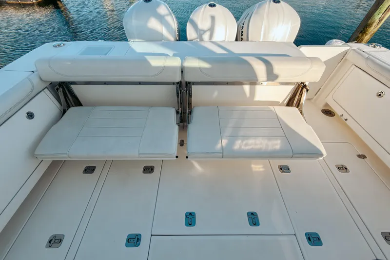 Slide: The Image of 2021 Pursuit OS 385 Offshore boat with foldable seating and triple outboard engines. - 20