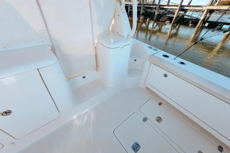 Slide: The Image of 2021 Pursuit OS 385 Offshore boat deck with storage compartments and fishing rod holders. - 27