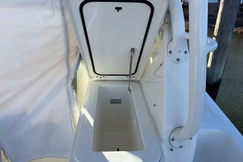 Slide: The Image of 2021 Pursuit OS 385 Offshore boat storage compartment with open hatch, showcasing interior space. - 28