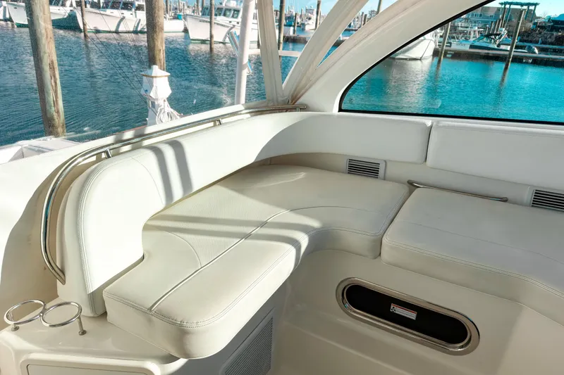 Slide: The Image of Luxurious seating area on a 2021 Pursuit OS 385 Offshore boat, docked at a marina. - 31