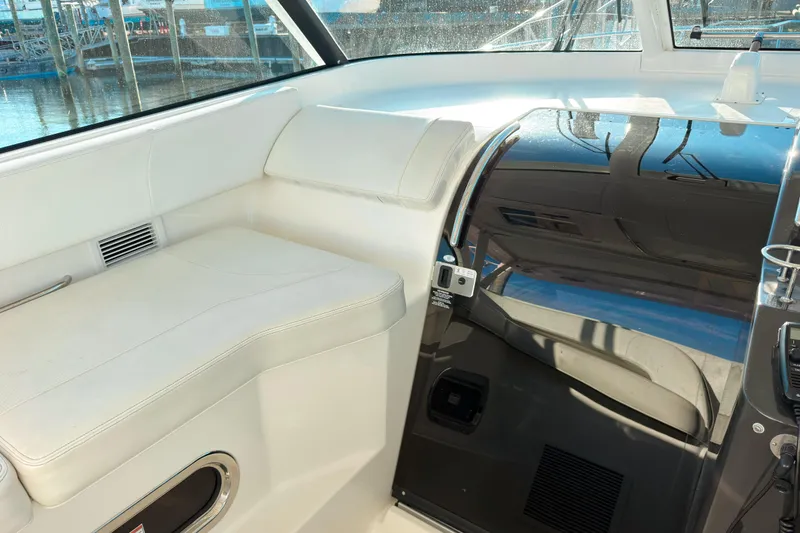 Slide: The Image of Interior of 2021 Pursuit OS 385 Offshore boat with white seating and sleek design. - 33
